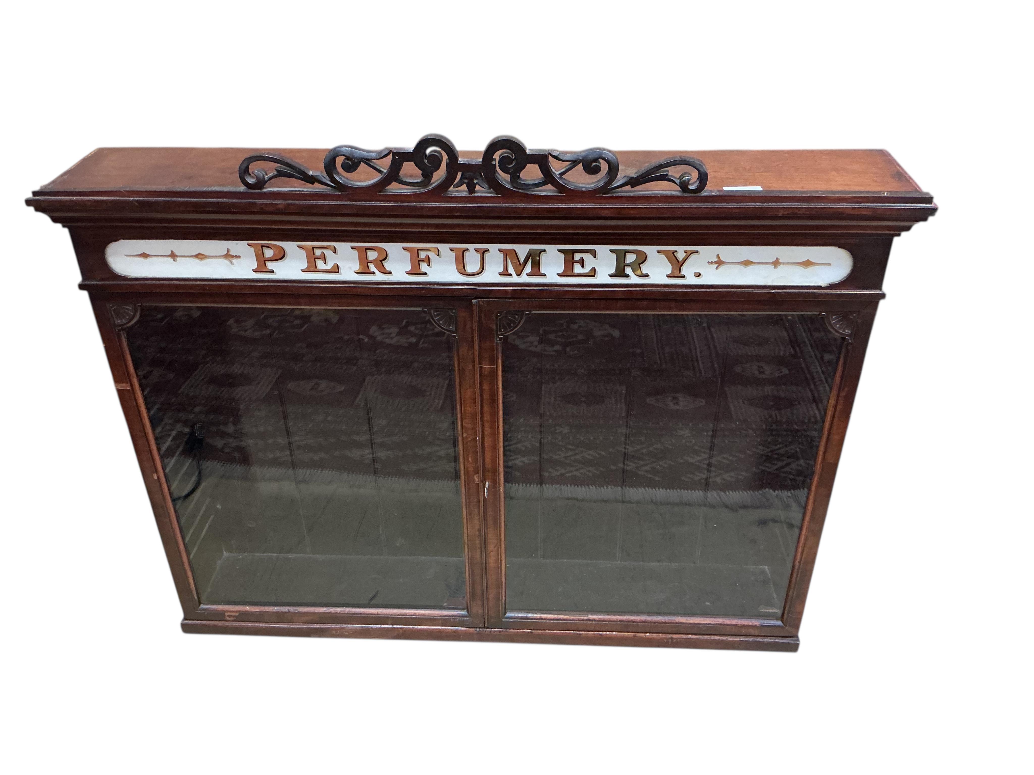 A late Victorian mahogany perfumery cabinet with printed glass frieze, width 95cm, depth 18cm, height 76cm